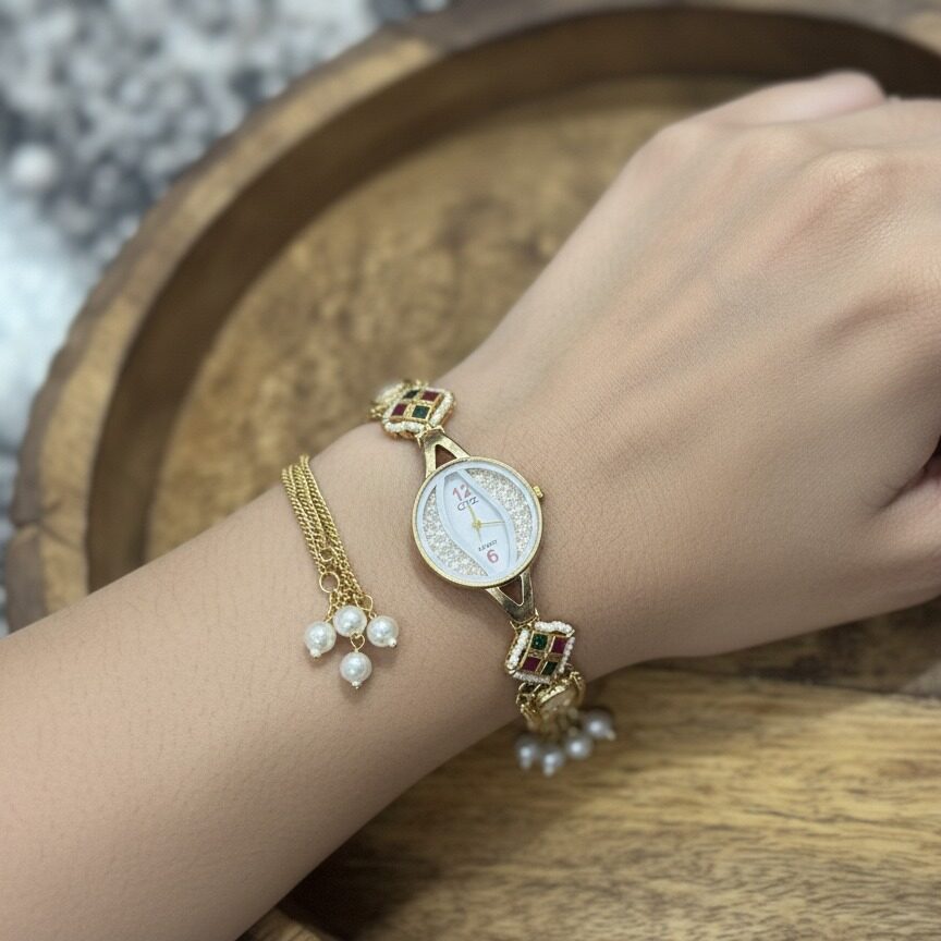 Gold kundan style watch bracelet with pearl tassels and chain detailing